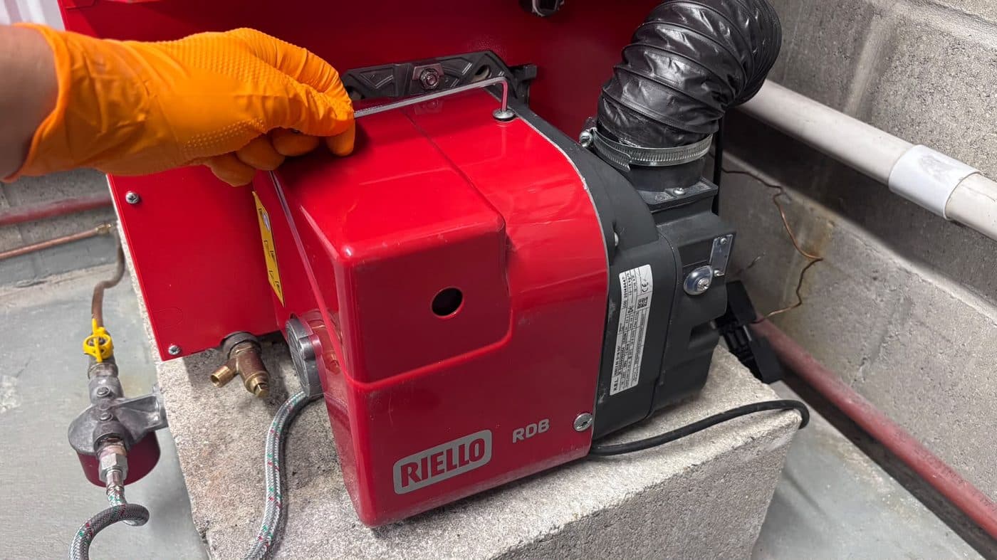 Step 1: Loosen the screws and remove the red Riello cover.
